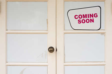 White closed door with coming soon messageの写真素材