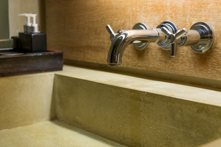 hot cold separated shiny metal water tap in bathroomの写真素材