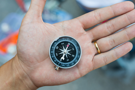 Metal compass on handの写真素材