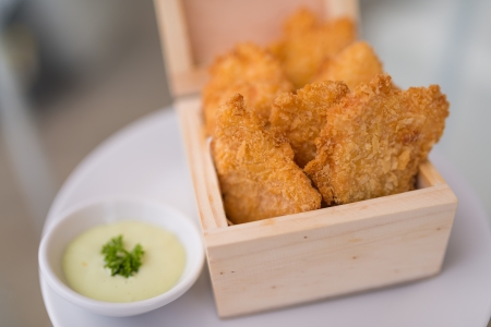 Crisp fish finger nugget in wooden boxの写真素材