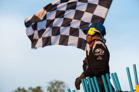 CHONBURI - APRIL 20,2014 : Marshall waving checker flag in Super One Race 2014 on April 20, 2014 at Bira International Circuit, Chonburi, Thailandのeditorial素材