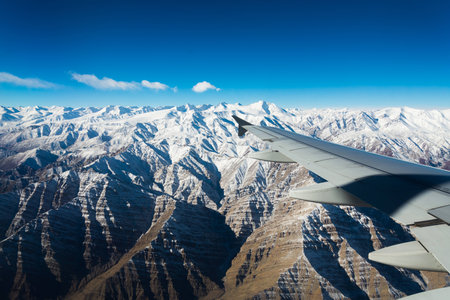 plane wing snow mountain viewの写真素材