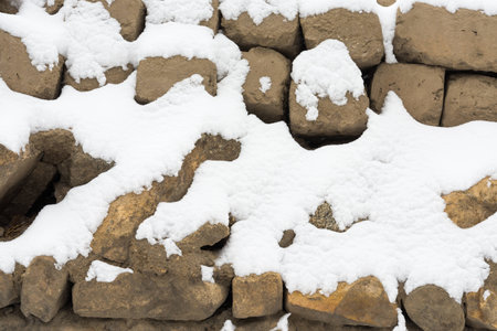 snow covered stone wall backgroundの写真素材