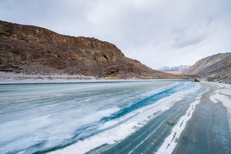 snow icy track on frozen riverの写真素材