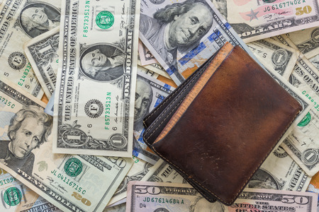 US dollar bills background with a wallet