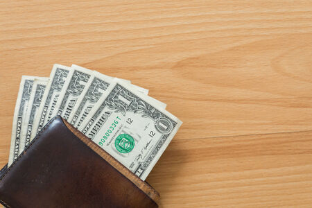 one dollar bills in wallet