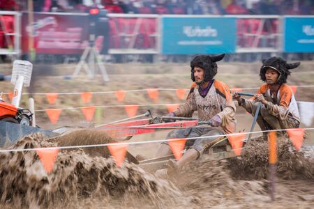 PIMAI - MARCH 14 : Unidentified tractor racer racing in Kubota mud track race event on March 14,...
