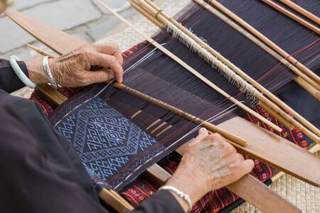 HAINAN  CHINA MAY 11 : Unidentified hill tribe weaving traditional clothes pattern in Hainan China on May 112015のeditorial素材