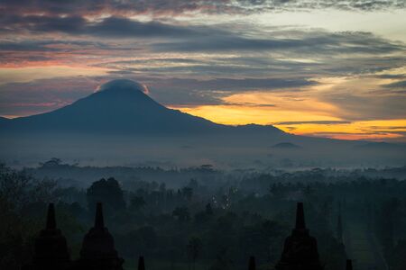 golden sky sunrise over Borobudur stupa with Mountain, Indonesiaの写真素材