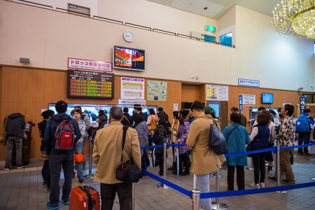 Tourists waiting in line for purchase Sagano romantic train at Torokko train station in Kyoto, Japan on November 8, 2015のeditorial素材