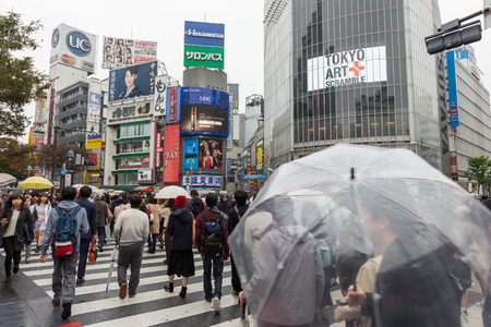 Tourists walking croos the road at famous Shibuya Crossing, Tokyo Japan
