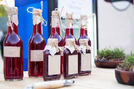 Glass bottles with Tkemali sauceの写真素材