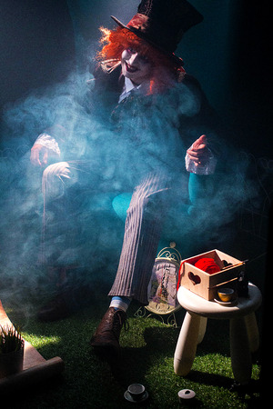 Hatter with red hair in smoke clubs on the lawnの写真素材