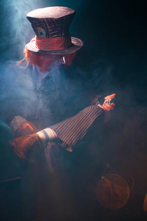 A view of a brooding hatter with a mirror through a beam of warm lightの写真素材