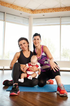 Two sports women with a childの写真素材