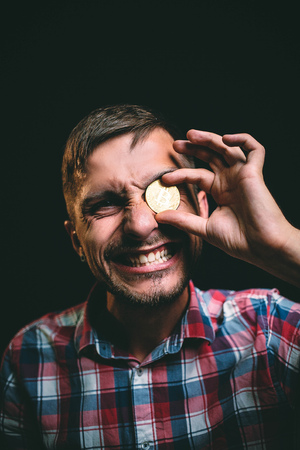 A man is rocky because he has a coin bitcoinの写真素材