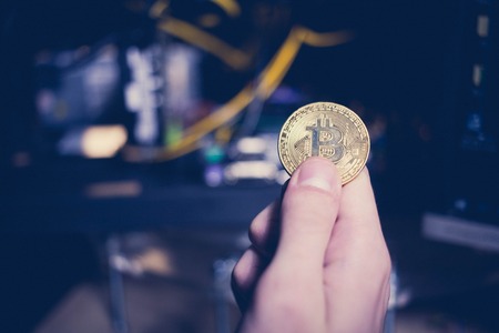 Businessman holding bitcoin in hand, bit coin BTC the new virtual electronic money, investment...
