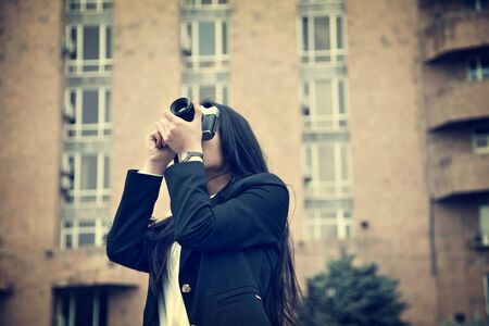 woman hand old camera on the streetの写真素材
