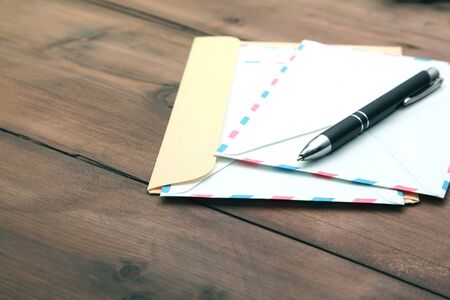 letters and pen on wooden tableの写真素材