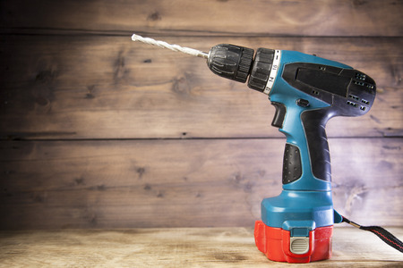 electric drill on a wooden backgroundの写真素材