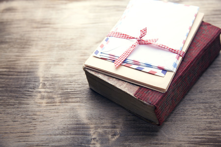 letters on the book on old wooden tableの写真素材