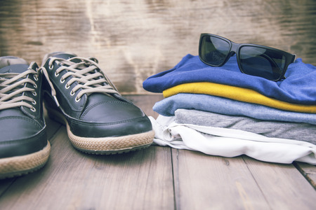 man sneakers and clothing on wooden tableの写真素材