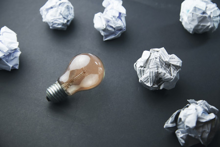 crumpled office paper and light bulbの写真素材