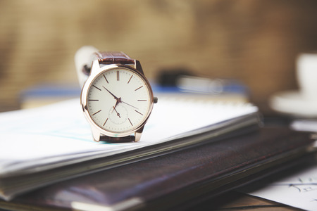 Notepad and watches on the deskの写真素材