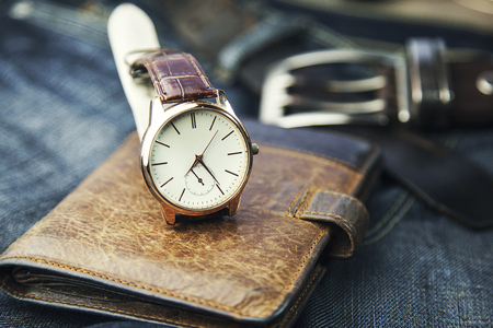 watch,wallet and jeans on tableの写真素材