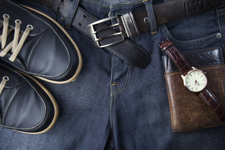 shoes.watch,wallet and jeans on tableの写真素材