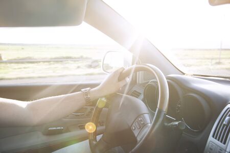 man driving car hand in the wheelの写真素材