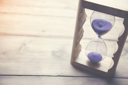 sand clock on the wooden table