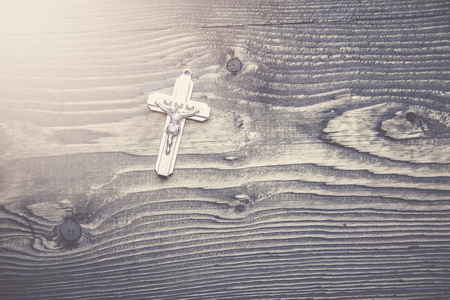 cross on the wooden table background