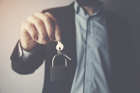 Men hand padlock and key on studio