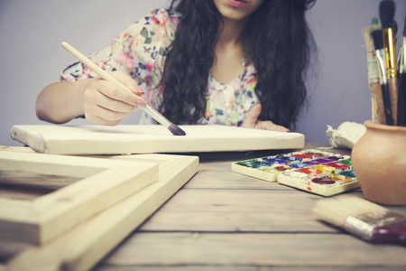 women hand with brush drawing on canvasの写真素材