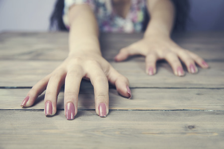 Woman two hands claw at backgroundの写真素材