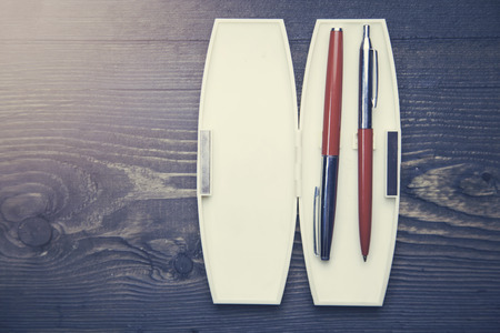 case with fountain pens on wooden tableの写真素材