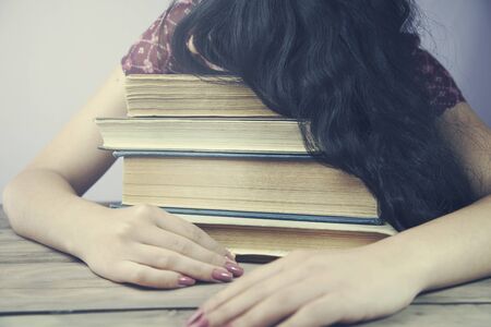 Young female with many study booksの写真素材