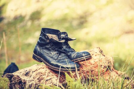 Hiking boots in the green meadow