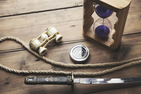 hourglass, telescope, compass and ropeon wooden tableの写真素材