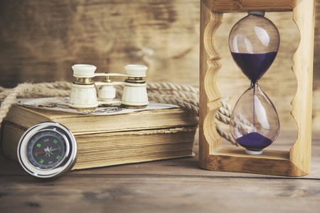 hourglass, telescope on the wooden tableの写真素材