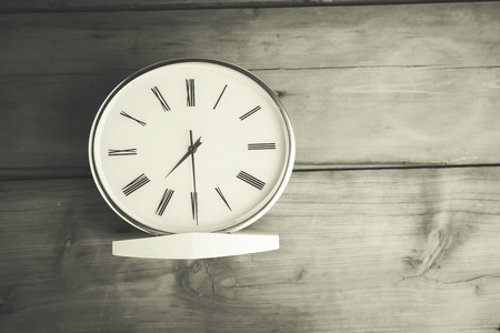 white clock on the wooden tableの写真素材