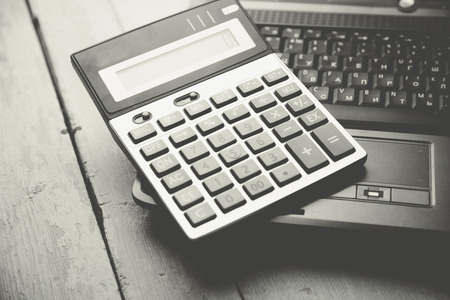 calculator on the laptop keyboard on tableの写真素材