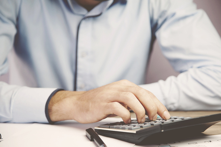 Hands of accountant business man with calculatorの写真素材