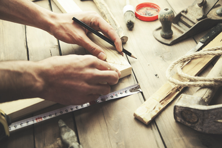 Artist canvas on man hand , canvas stretcher and staple gun on tableの写真素材