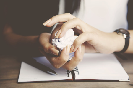 woman hand paper on wooden tableの写真素材