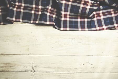 checkered tablecloth on the wooden tableの写真素材