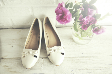 woman shoes and  pink rose on brick wall backgroundの写真素材