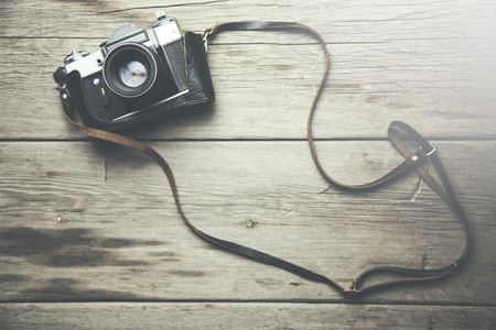 Vintage film camera on wooden table