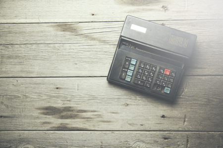 old calculator on the  wooden tableの写真素材